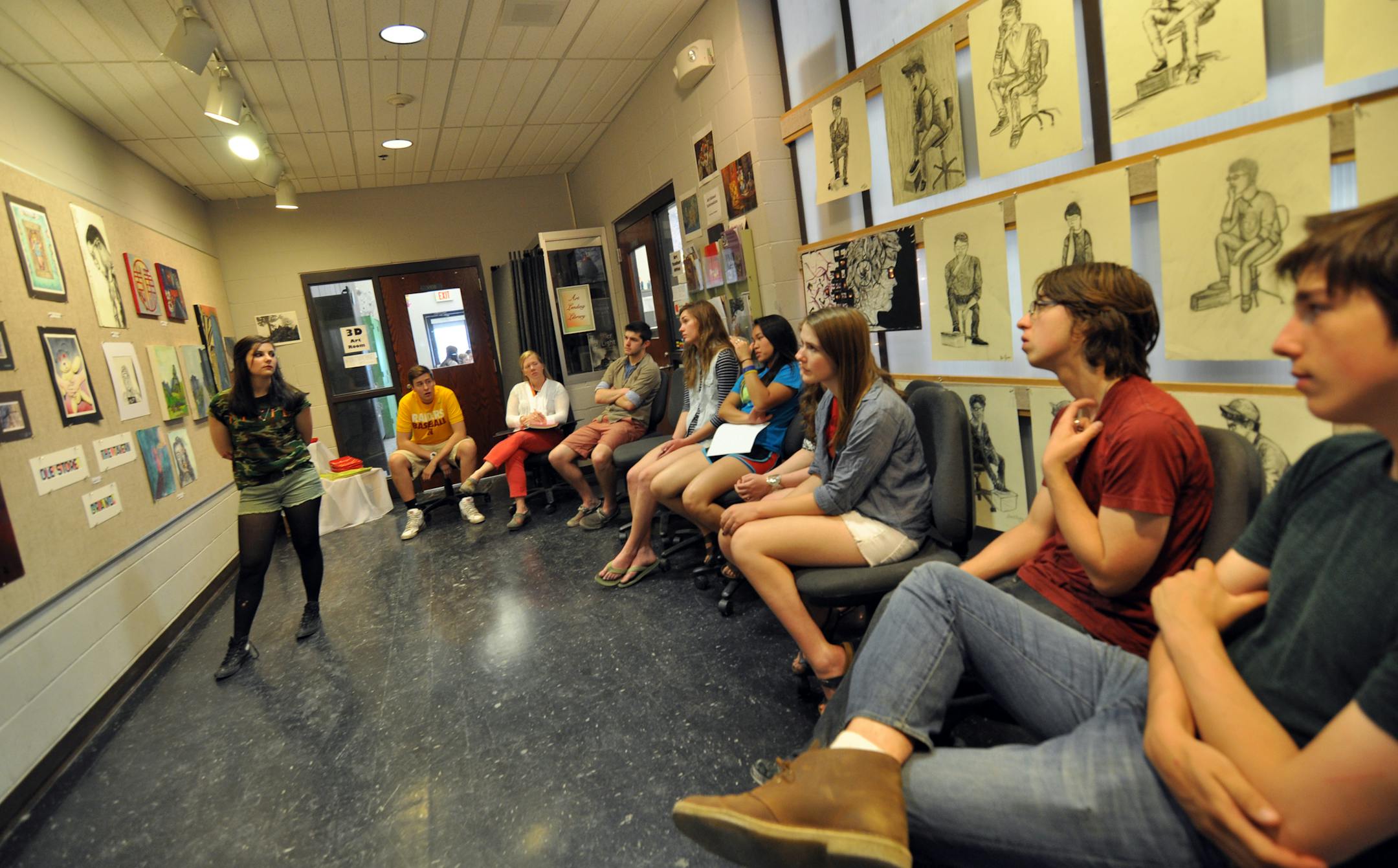 Photo by LIz Rolfsmeier Kylie Sletten, 18, gets critique from her classmates during honors art class at Northfield High School.