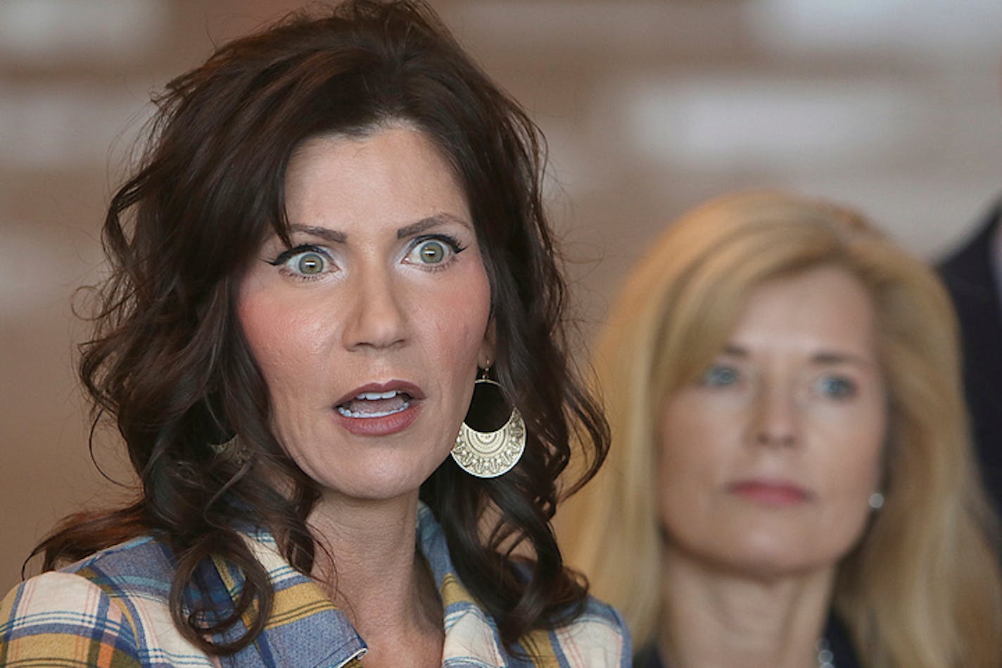 South Dakota Gov. Kristi Noem, left, updated media on the COVID-19 pandemic during a news conference March 18.