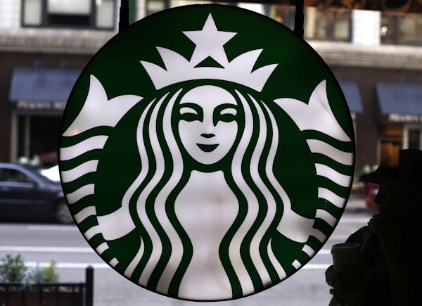 FILE - This Saturday, May 31, 2014, file photo, shows the Starbucks logo at one of the company's coffee shops in downtown Chicago.