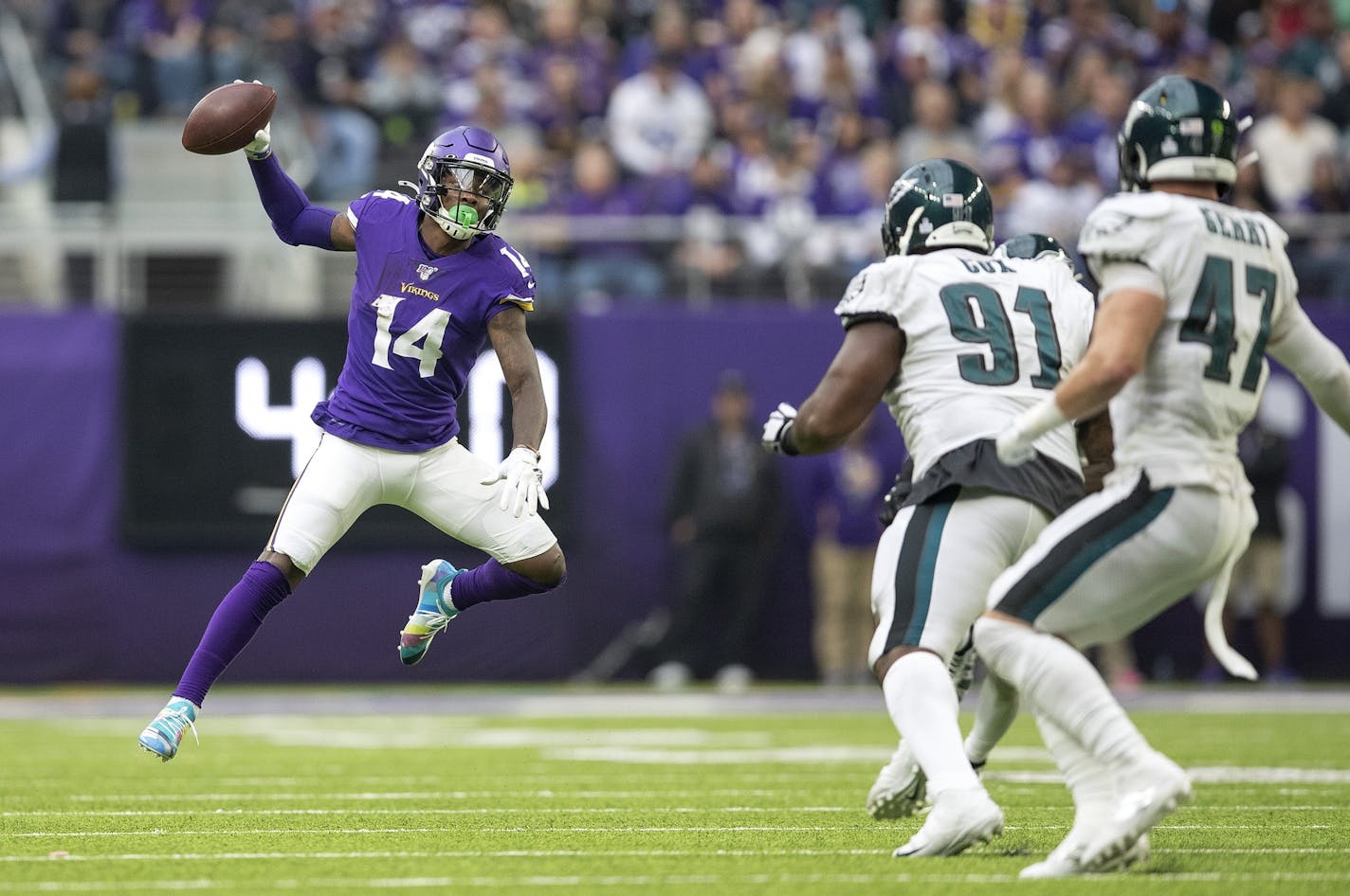 Vikings wide receiver Stefon Diggs faked a pass in the third quarter as Eagles defenders Fletcher Cox and Nate Gerry (47) chased him.