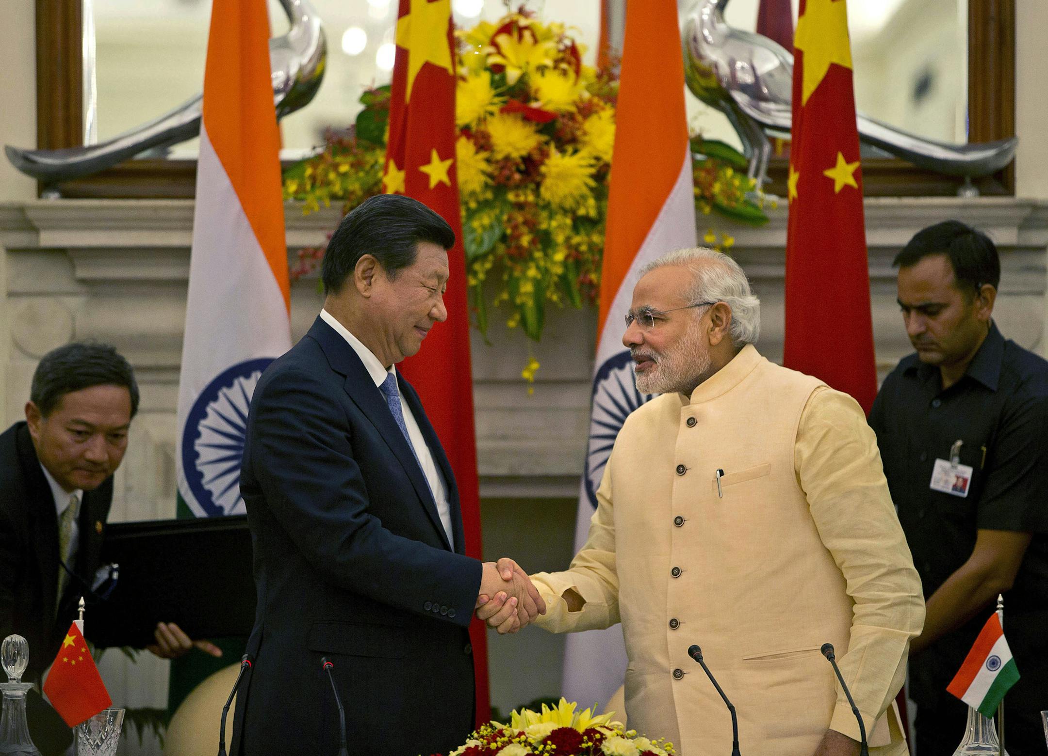 Chinese President Xi Jinping shakes hands with Indian Prime Minister Narendra Modi, right after signing agreements in New Delhi, India, Thursday, Sept. 18, 2014. Xi vowed to bring prosperity to Asia and create opportunities for the world as he and Modi began talks Thursday to deepen cooperation through investment and trade. (AP Photo /Manish Swarup) ORG XMIT: DEL139