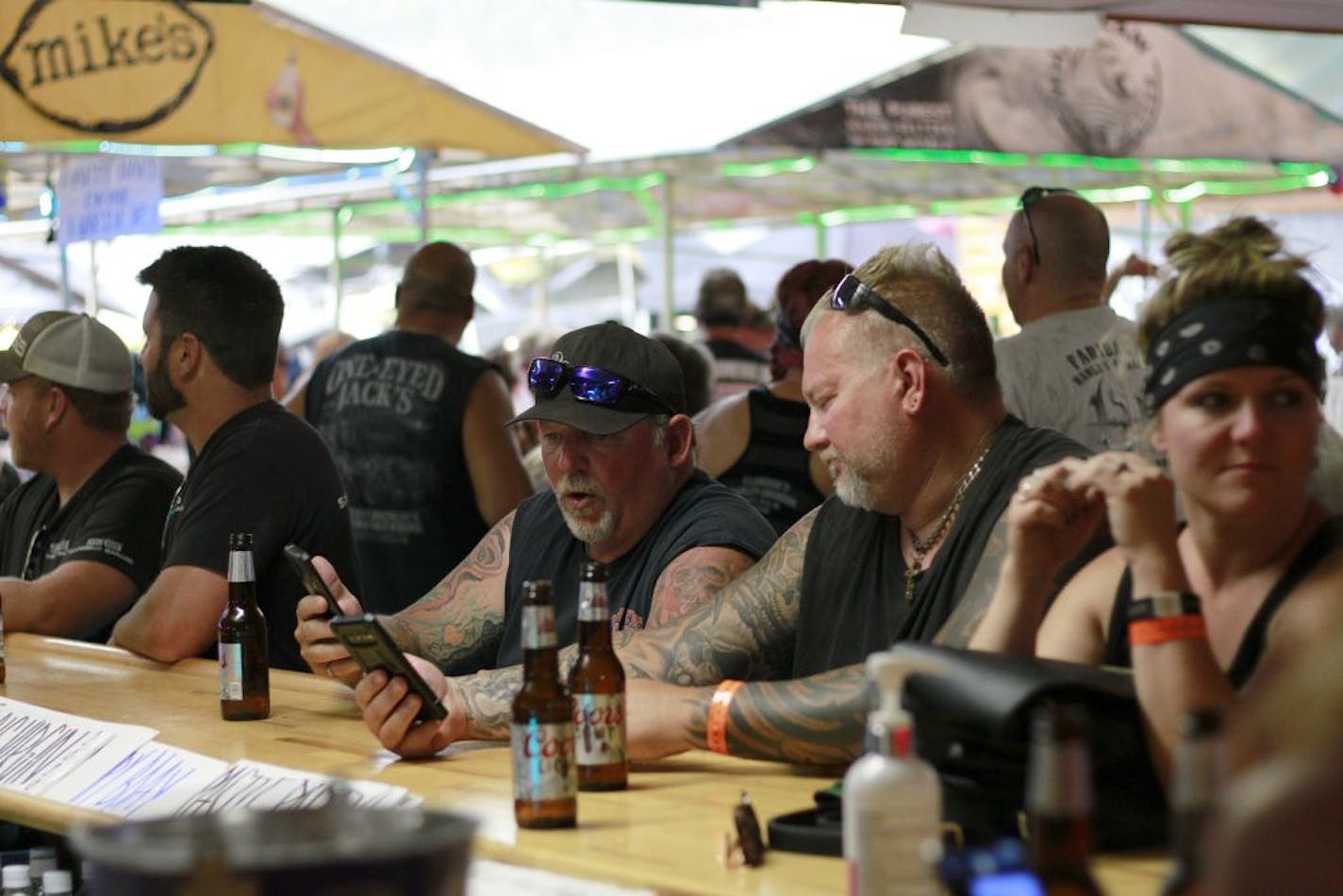 FILE - In this Aug. 7, 2020, file photo, people congregate at One-Eyed Jack's Saloon during the 80th annual Sturgis Motorcycle Rally in Sturgis, S.D. Coronavirus infections in the Dakotas are growing faster than anywhere else in the nation. Infections have been spurred by schools and universities reopening and mass gatherings like the Sturgis Motorcycle Rally, which drew hundreds of thousands of people from across the country.