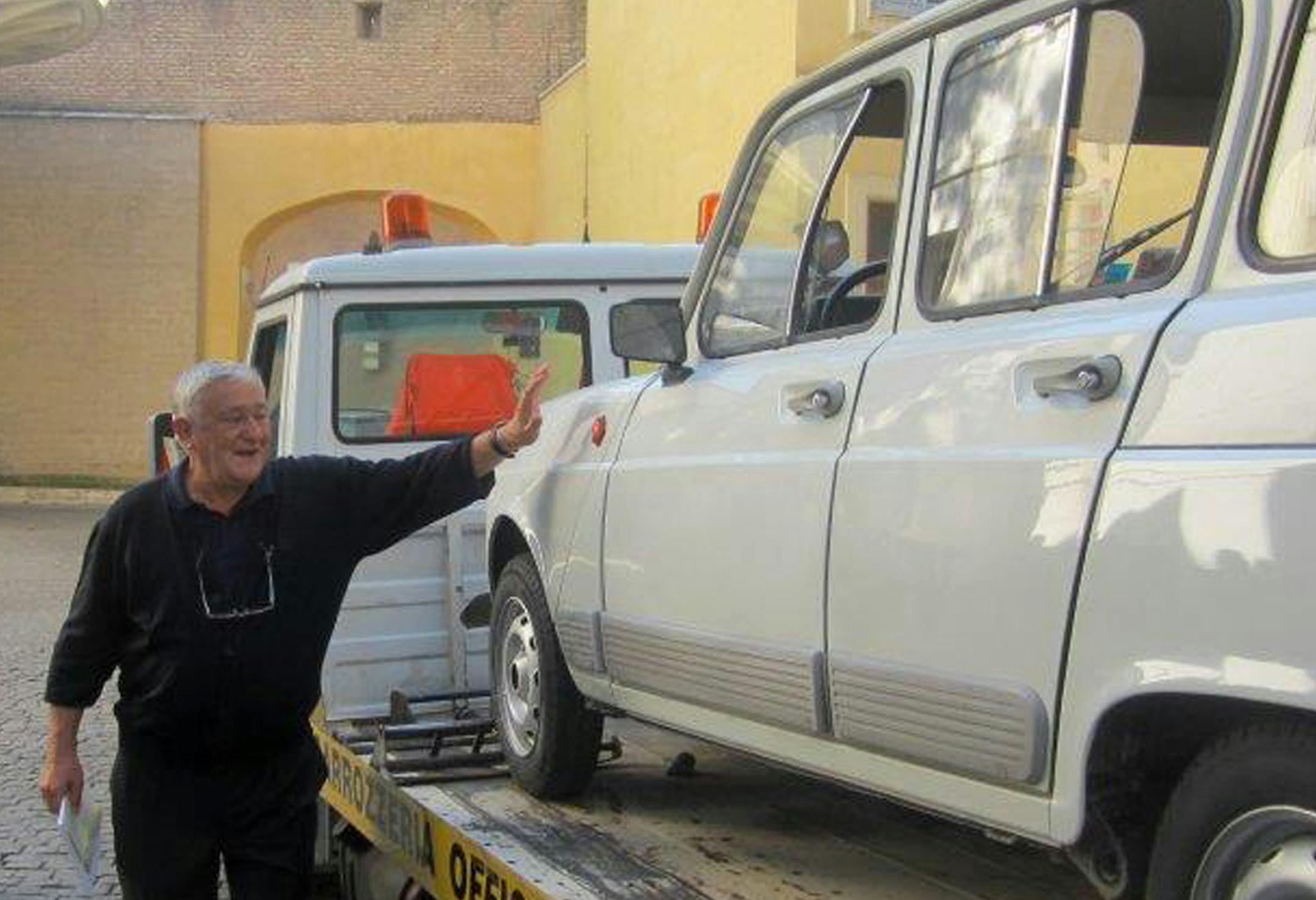 In this picture taken with a smartphone on Saturday, Sept. 7, 2013 and provided by NGO Fondazione L'Ancora ONLUS, Rev. Renzo Zocca, parish priest of Santa Lucia di Pescantina, in Verona, northern Italy, pats his Renault 4L as it is brought inside the Vatican to be donated to Pope Francis. Rev. Zocca, 70, told the Associated Press on Wednesday, Sept. 11, 2013, that he has dedicated his life to helping the needy on the outskirts of Verona, so when he saw that Pope Francis' priority was to reach ou