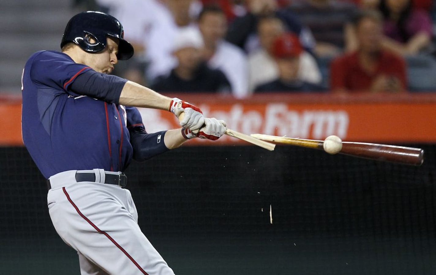 Minnesota Twins' Justin Morneau breaks his bat as he grounds out against the Los Angeles Angels during the second inning of a baseball game in Anaheim, Calif., Monday, April 30, 2012.