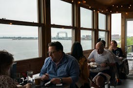 Restaurant-goers dine with views of Lake Superior in an enclosed solarium perched above the Lakewalk at Va Bene Caffe in Duluth on Sunday.