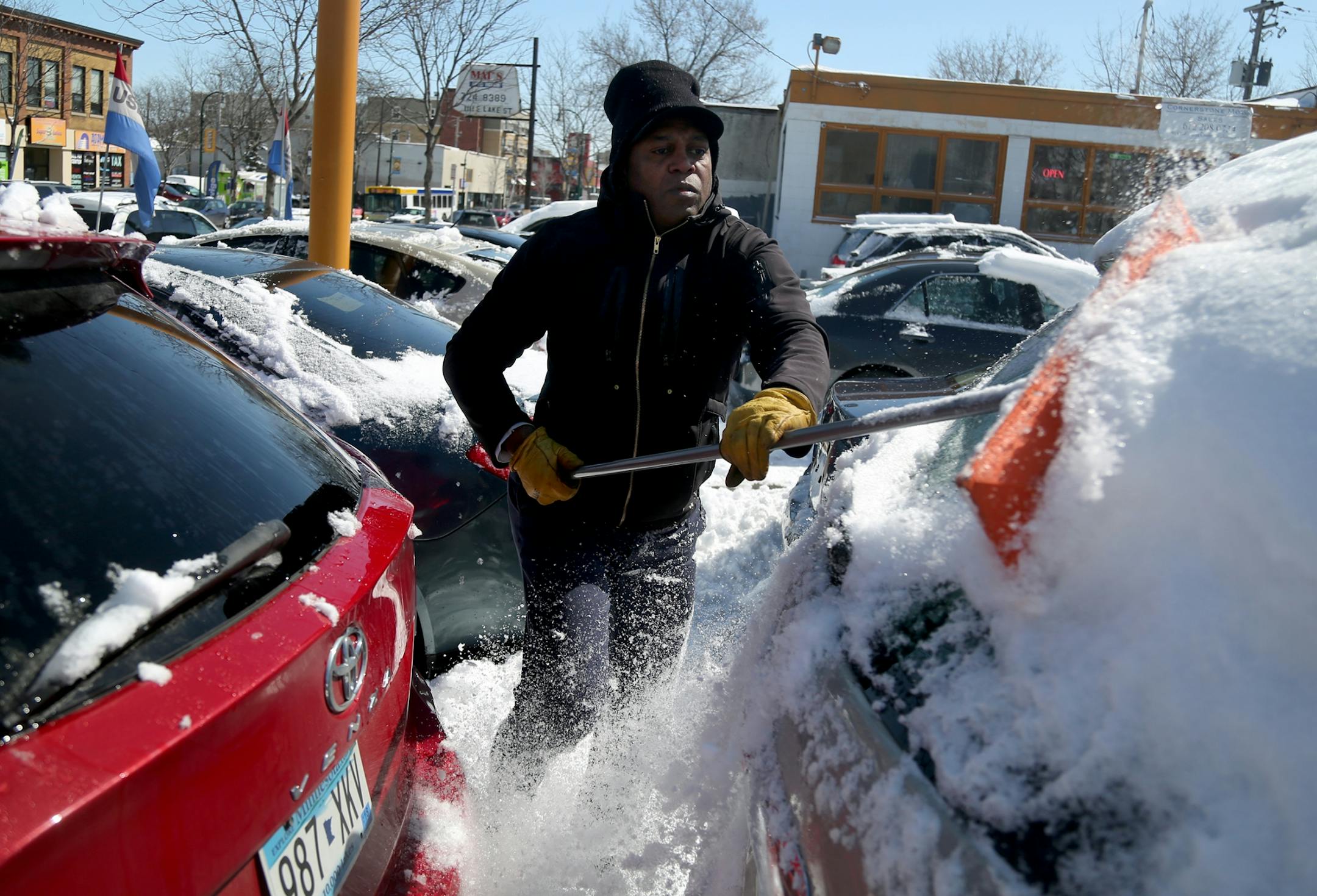 Star King had the unspring-like task of removing snow from vehicles for sale at a used auto lot on Lake St. Wednesday, April 4, 2018, in Minneapolis, MN. "Winter is supposed to have come and gone by now," King said.
