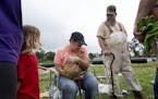 Terri Webb holds her sisters cat after the cat was found Monday, May 11, 2015. The soaking wet cat was freed when a piece of heavy equipment lifted a 