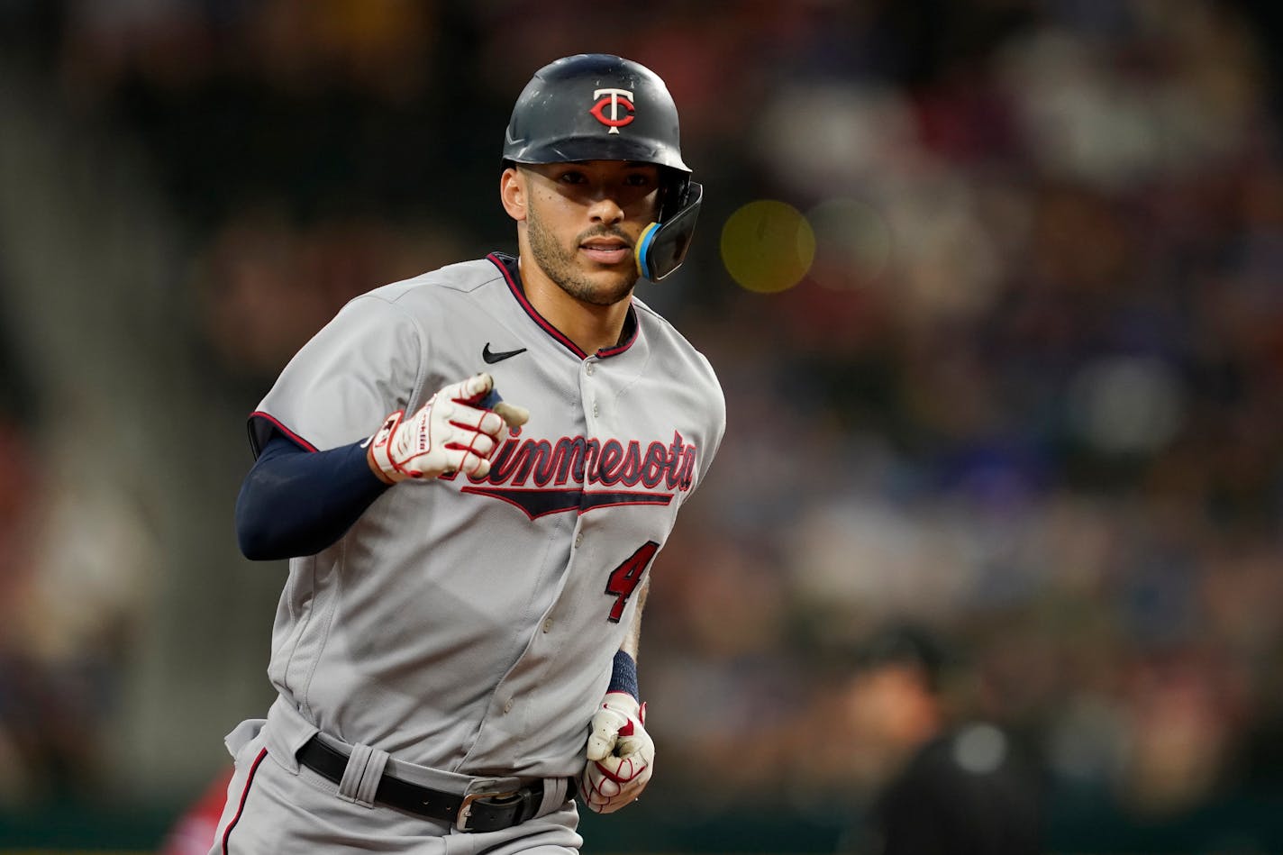 Minnesota Twins' Carlos Correa points as he rounds third after hitting a two-run home run in the first inning of the team's baseball game against the Texas Rangers, Friday, July 8, 2022, in Arlington, Texas. (AP Photo/Tony Gutierrez) ORG XMIT: MERaaf9f1cd441fc882a5ba7240db397