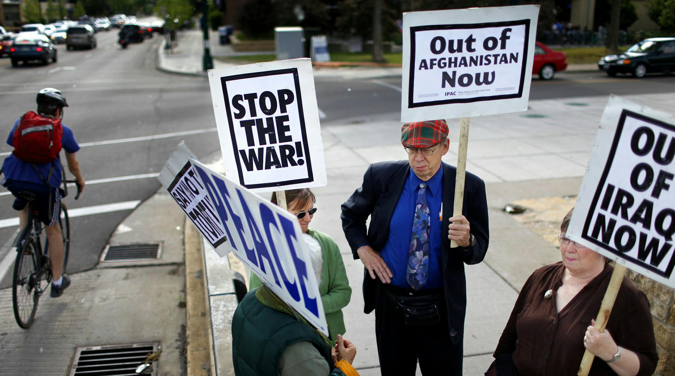 Anthony Souffle ‚Ä¢ anthony.souffle@startribune.com Minneapolis, Minn. - June 10, 2009 - ] Fresh off a flight from Denver, Charles Nichols, center, and his fiancee Sally Ortiz, right, grabbed a pair of signs and joined in the weekly protest held by the Women Against Military Madness Wednesday, June 10th at the Lake Street and Marshall Ave Bridge. "We thought by coming to a protest we would meet a better class of people," said Nichols who was visiting relatives. ORG XMIT: MIN2014