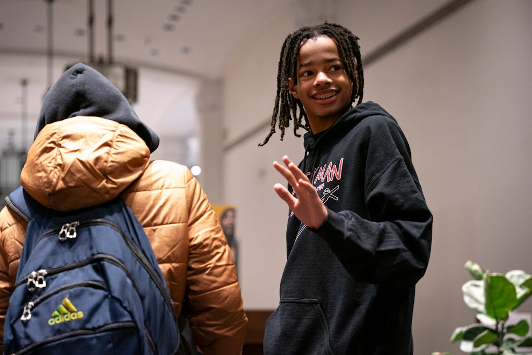 Seventh-grader Miles Asberry-Wallace greeted guests who have come to support him after publishing his first book, “Kings of Quests: A Tale of Bros” at an event for St. Paul Youth Services (SPYS) at Strive Publishing and Bookstore on Wednesday in Minneapolis. 