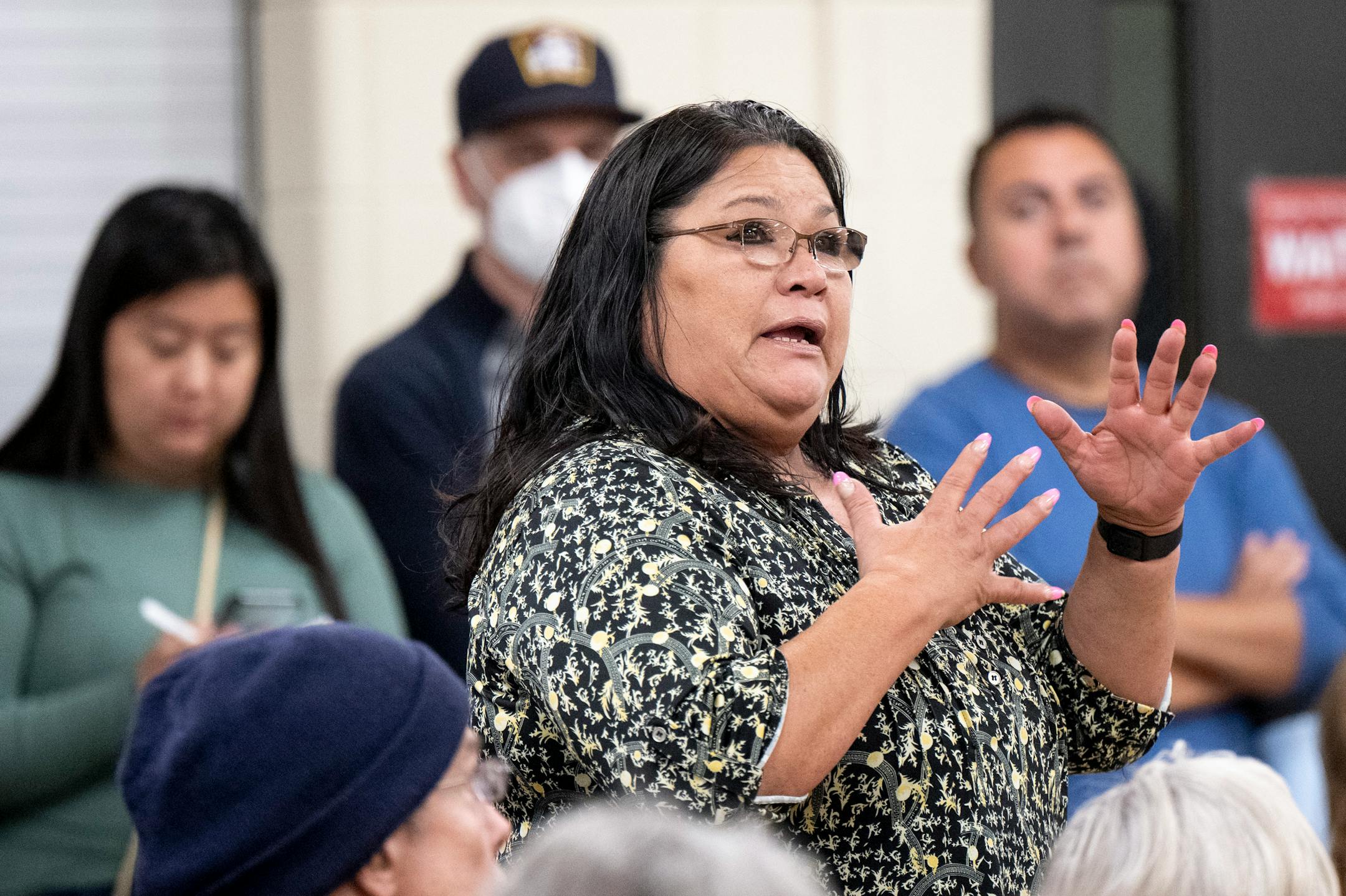 Penny St. Clair, of Minneapolis, expresses opposition to the nearby encampments and the risks they pose to residents during a meeting.