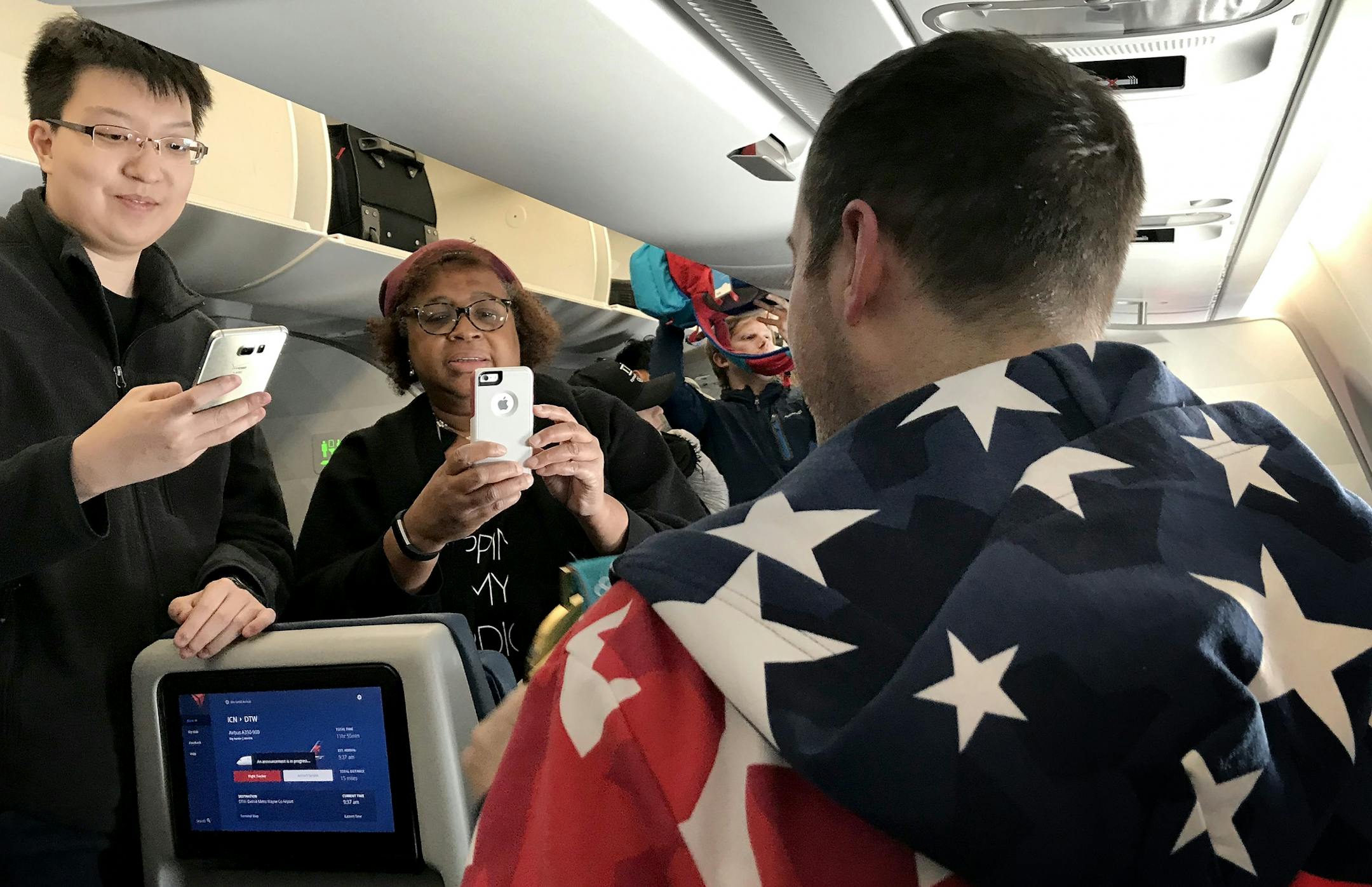 Passengers took photos of Tyler George with the gold medal on the flight home from South Korea.