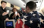 Passengers took photos of Tyler George with the gold medal on the flight home from South Korea.
