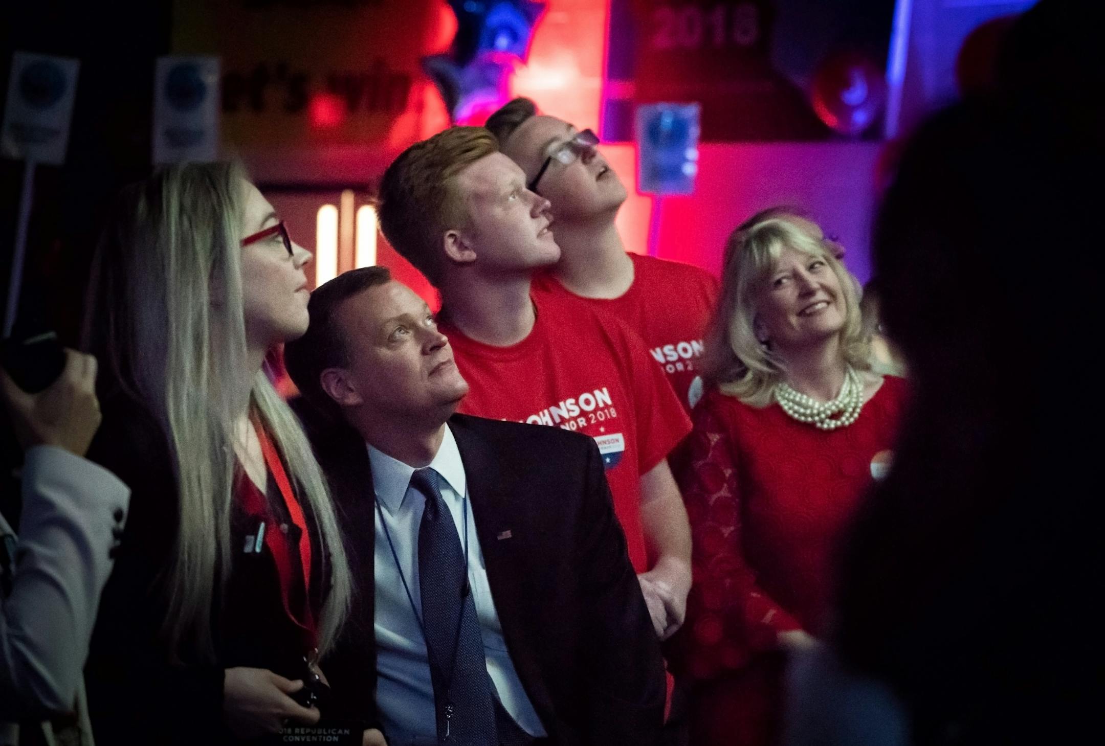 Sondi Johnson looked over at her husband Jeff and smiled as they watched a promotional video about Jeff's life and candidacy. In the middle are their sons Thor and Rolf.