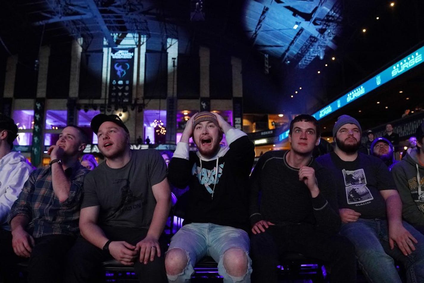 From left, friends Andrew Schafer, Scott Weinand, Phillip Fisher (with his hands on his head), and Abe Harder watched as the Seattle Surge played the Florida Mutineers in Call of Duty on Friday night at the Armory.