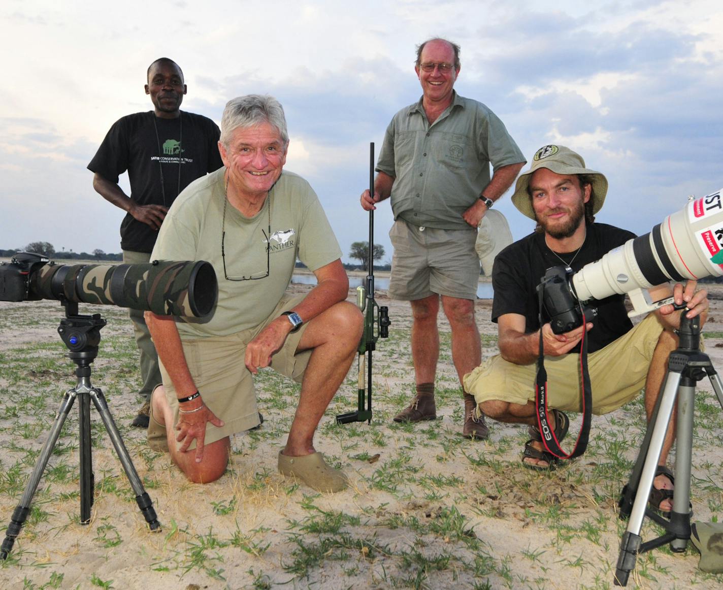 In this photo taken Nov. 9, 2014, photographer Brent Stapelkamp, front right, with colleagues in the Hwange National Park, Zimbabwe. Stapelkamp, a lion researcher and part of a team that had tracked and studied Cecil the lion for nine years darted him and attached a collar last year.