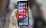 FILE - This Sept. 12, 2018, file photo shows an Apple iPhone XR on display at the Steve Jobs Theater after an event to announce new products, in Cuper