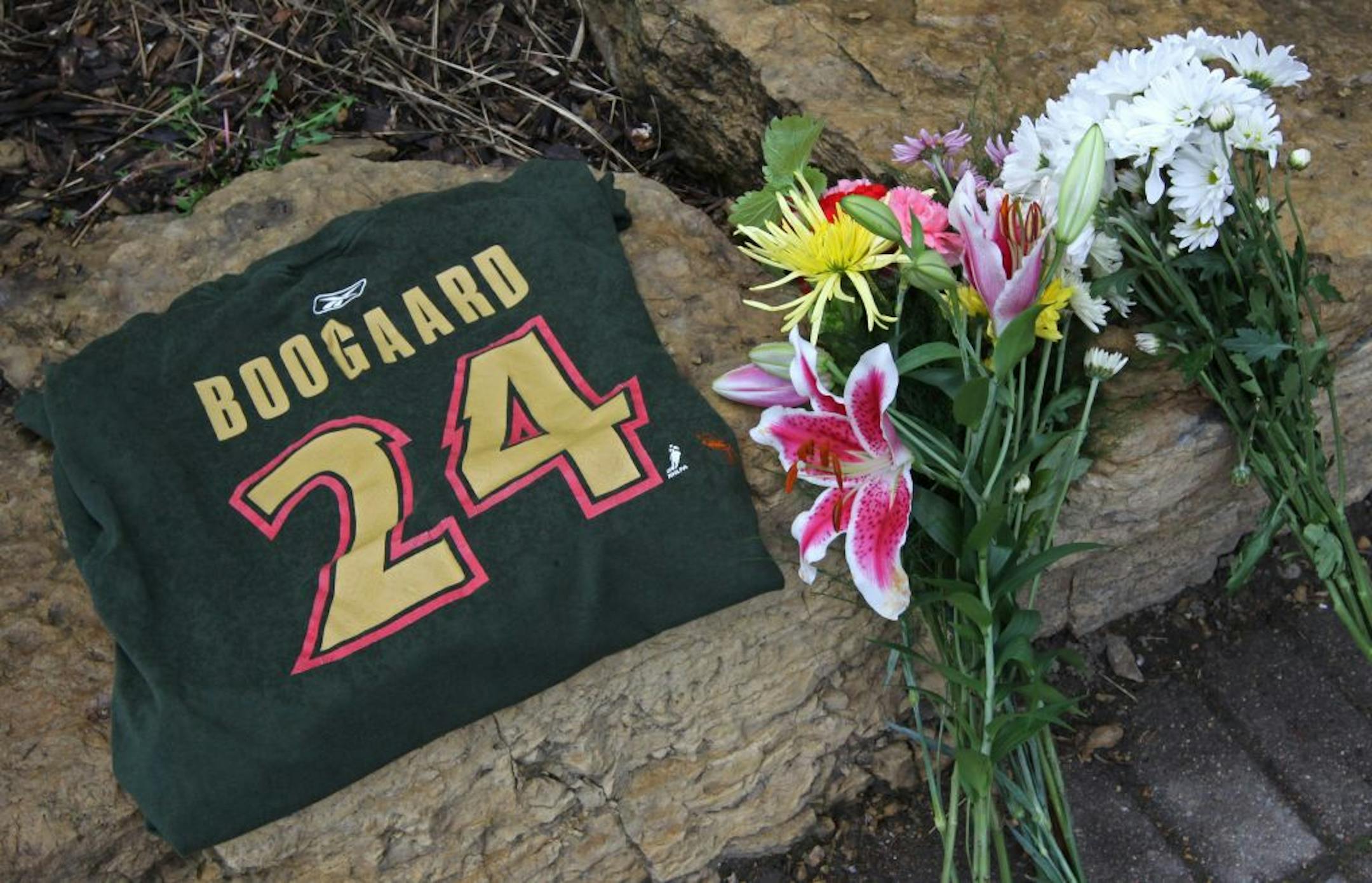Hockey fans left a Derek Boogaard t-shirt and bundles of flowers outside of the Xcel Energy Center where Boogaard was a member of the Minnesota Wild for five seasons.