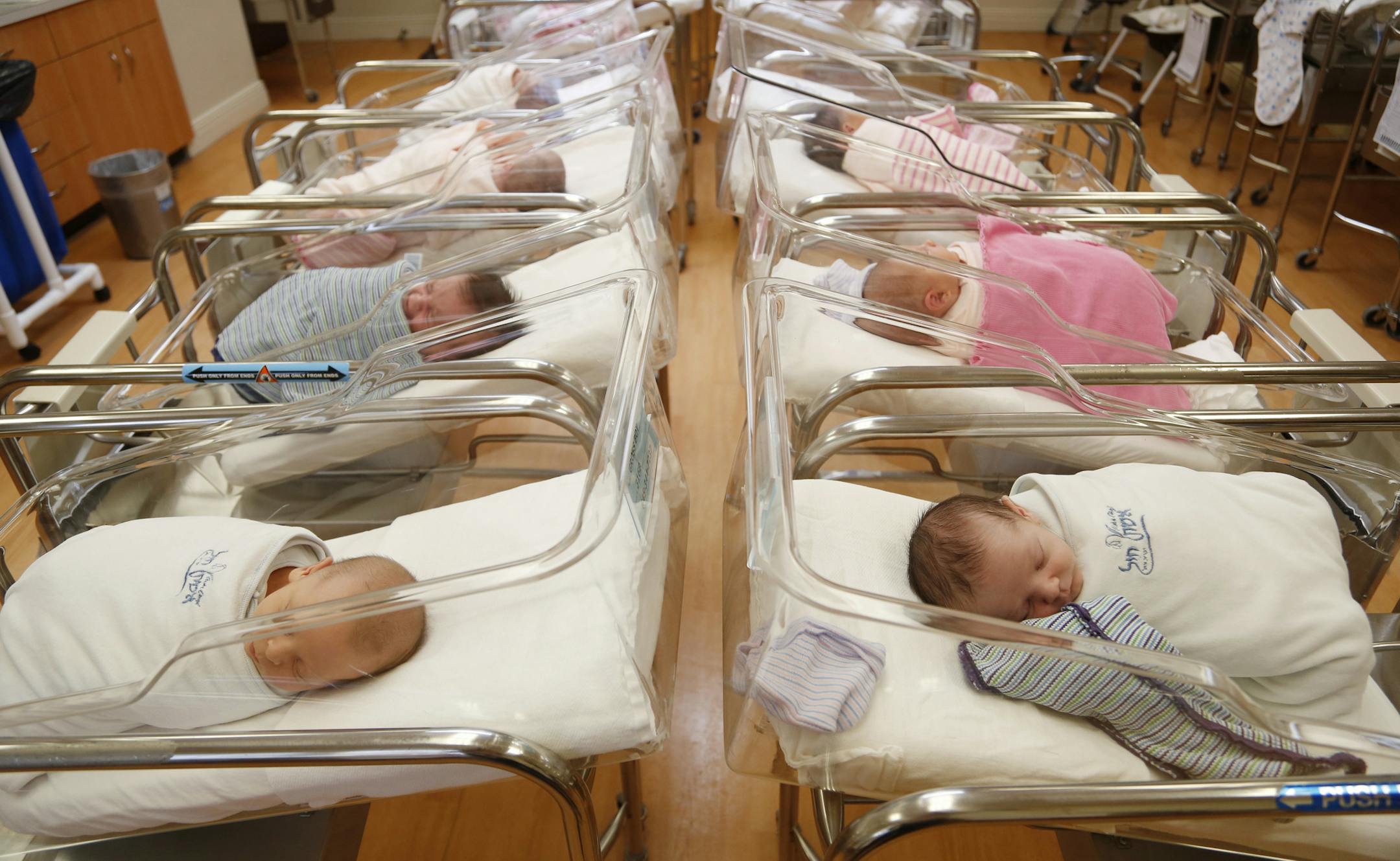 FILE - In this Feb. 16, 2017, file photo newborns rest in the nursery of Aishes Chayil, a postpartum recovery center, in Kiryas Joel, N.Y. Some parents are discovering that the Social Security number assigned to their newborn is being used by criminals to commit fraud. Identity theft experts recommend that parents freeze their children’s credit now to help prevent problems in the future. (AP Photo/Seth Wenig, File)