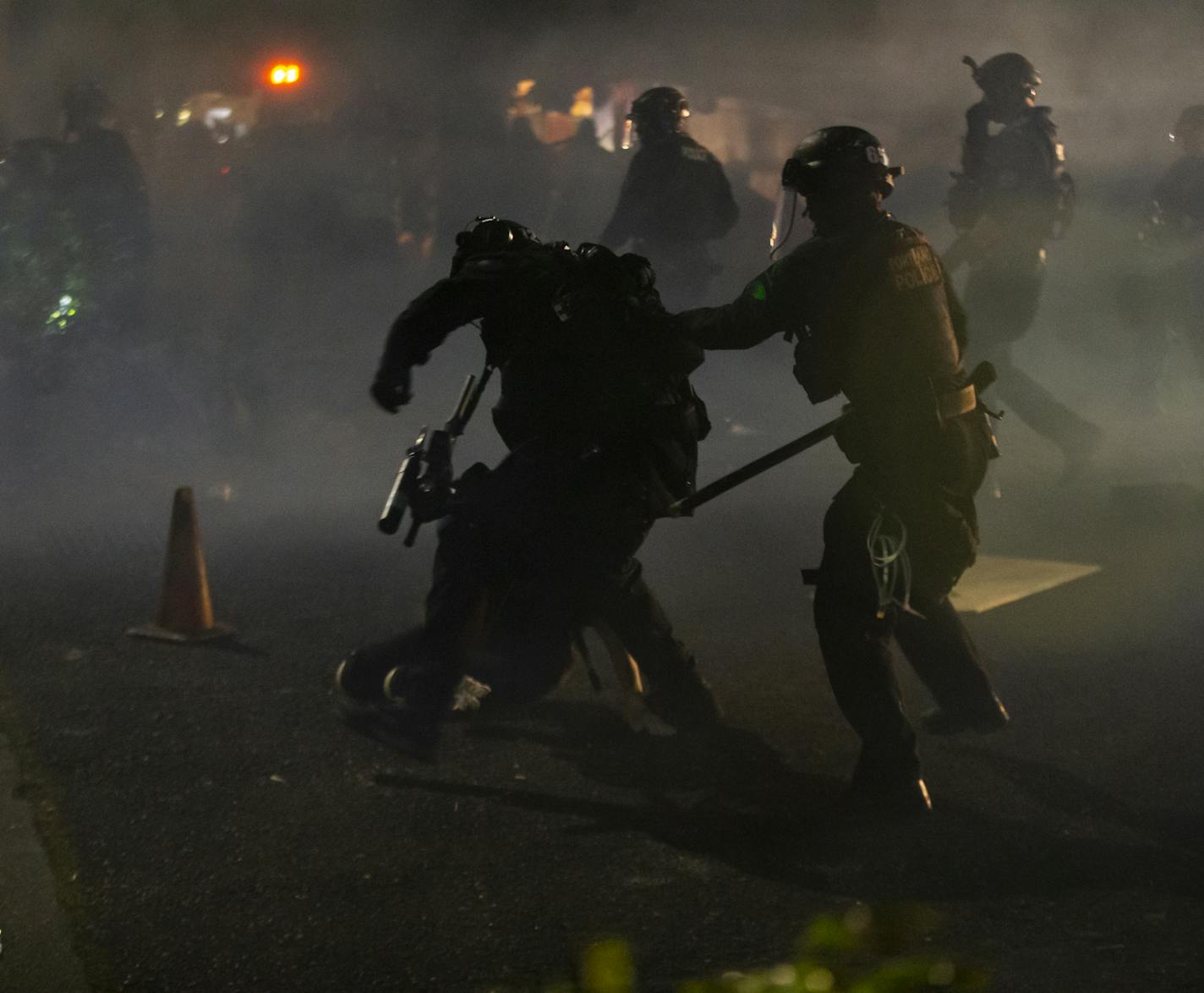 Police declared a riot around midnight as Portland protests continued for the 80th consecutive night Saturday, Aug. 15, 2020. Protesters gathered at Laurelhurst Park Saturday evening before marching to the Penumbra Kelly building. (Dave Killen/The Oregonian via AP)