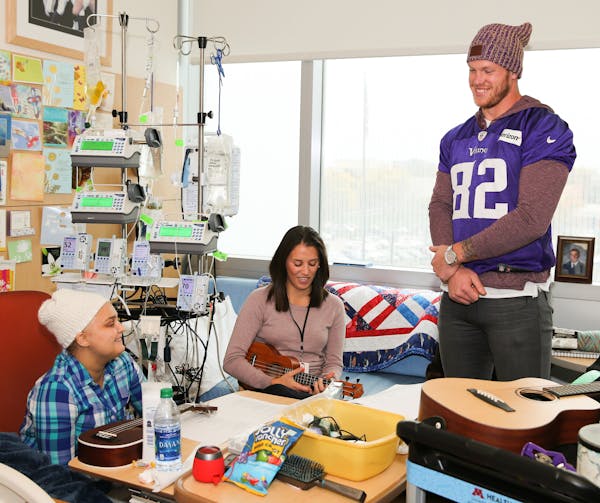 Vikings Kyle Rudolph along with other players visit with families at Children&#xed;s Hospital.