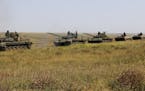 A column of Ukrainian tanks and APCs move towards the de-facto border with Crimea near Kherson, southern Ukraine, Friday, Aug. 12, 2016. Ukraine put i