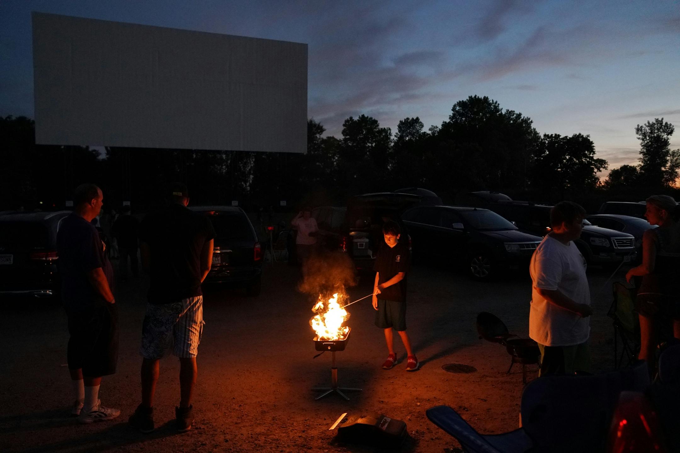 A boy grilled marshmallows over an open flame before the start of Friday night's show.