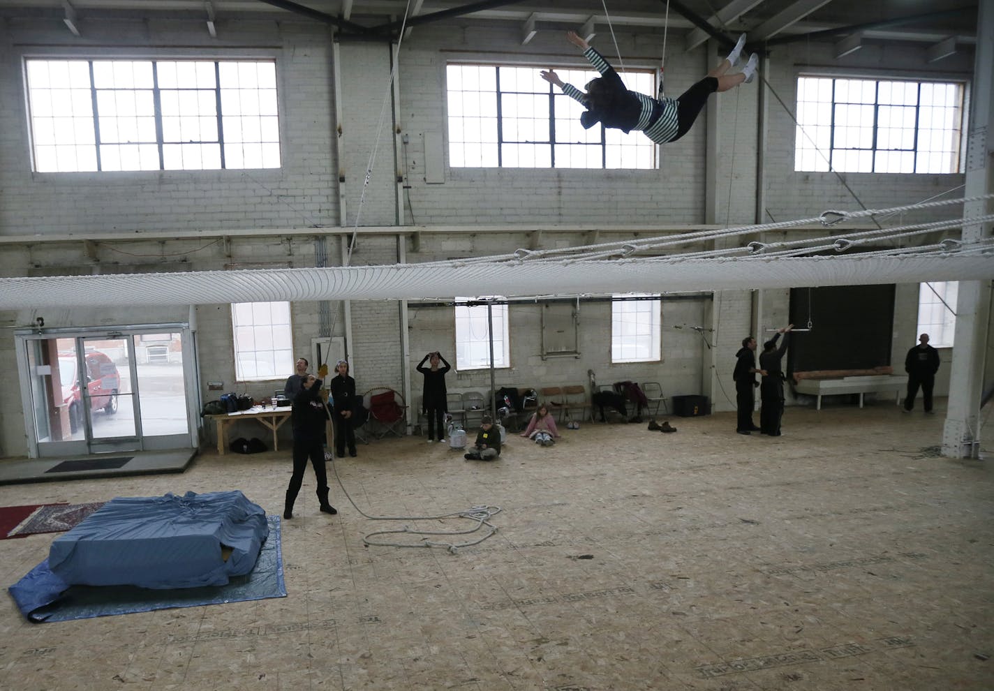 Katie Kimball instructor at the trapeze school tugged on a safety rope helping Lindsey Valentini with her routine during a small class Sunday March, 10, 2013 at a new trapeze school in the old Hamm's brewery in St. Paul, MN.] JERRY HOLT &#x201a;&#xc4;&#xa2; jerry.holt@startribune.com