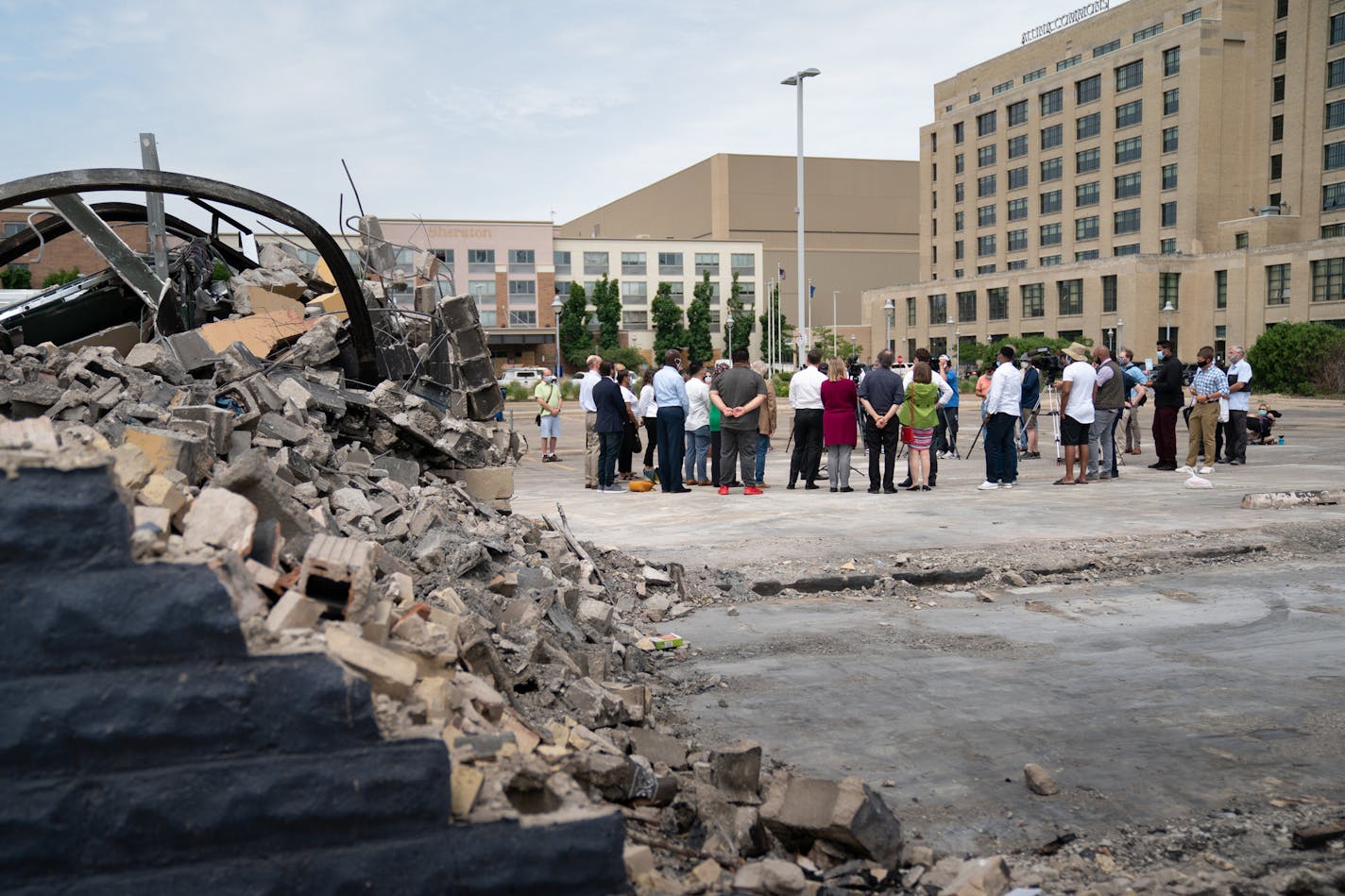 In the Lake Street parking lot with the burned out Foot locker store behind them, and next to the Midtown Global Market, state legislators who represent the most impacted areas from civil unrest announced the PROMISE Act — a comprehensive plan to help area businesses rebuild and recover.