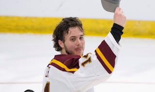 Minnesota Gophers defenseman Brock Faber (14) held up his regional champion's hat after the win over the Huskies. The University of Minnesota Gophers 