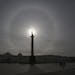 A giant circle is seen during the solar eclipse around the sun over Alexander Column at Dvortsovaya (Palace) Square in St.Petersburg, Russia, Friday, 