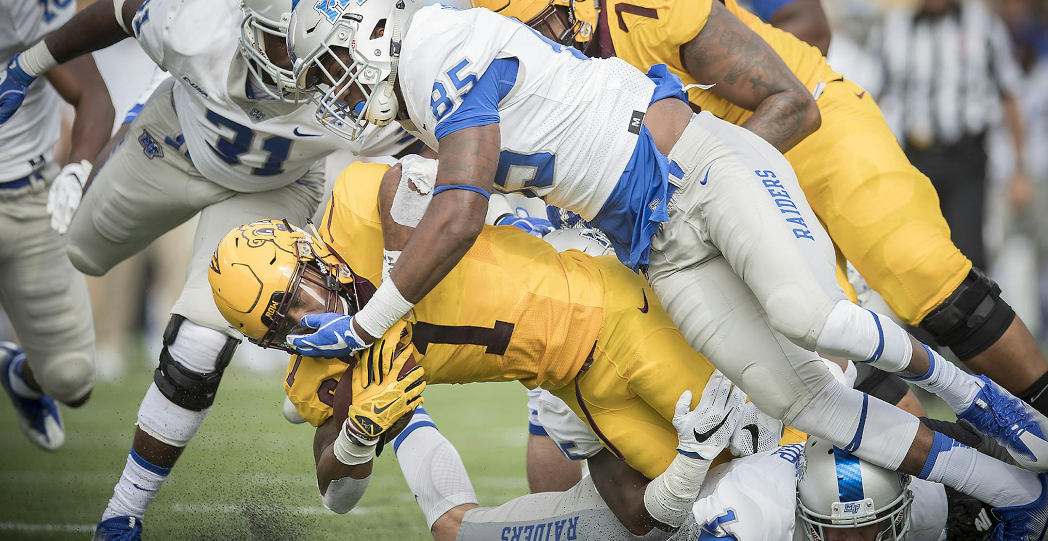 Minnesota's running back Rodney Smith is brought down after a short gain by Middle Tennessee's defensive end Darrius Liggins during the first quarter as the Gophers took on Middle Tennessee at TCF Bank Stadium, Saturday, September 16, 2017 in Minneapolis, MN. ] ELIZABETH FLORES ï liz.flores@startribune.com