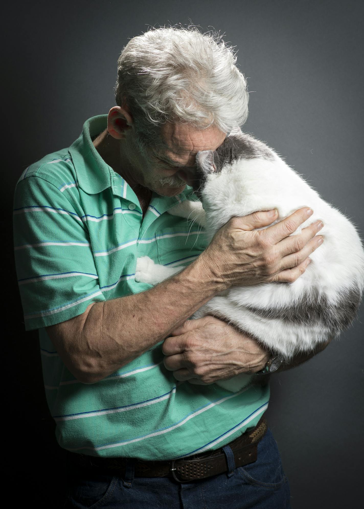 Dave Long shares a moment with Romeo, a 3-year-old short-haired cat that he and his wife Gayle enter into cat shows. ] (Aaron Lavinsky | StarTribune) Gayle and Dave Long show their two cats, Gypsy Rose and Romeo, for a preview feature leading up to the Saintly City Cat Show. They were photographed in their home Tuesday, Jan. 14, 2015.