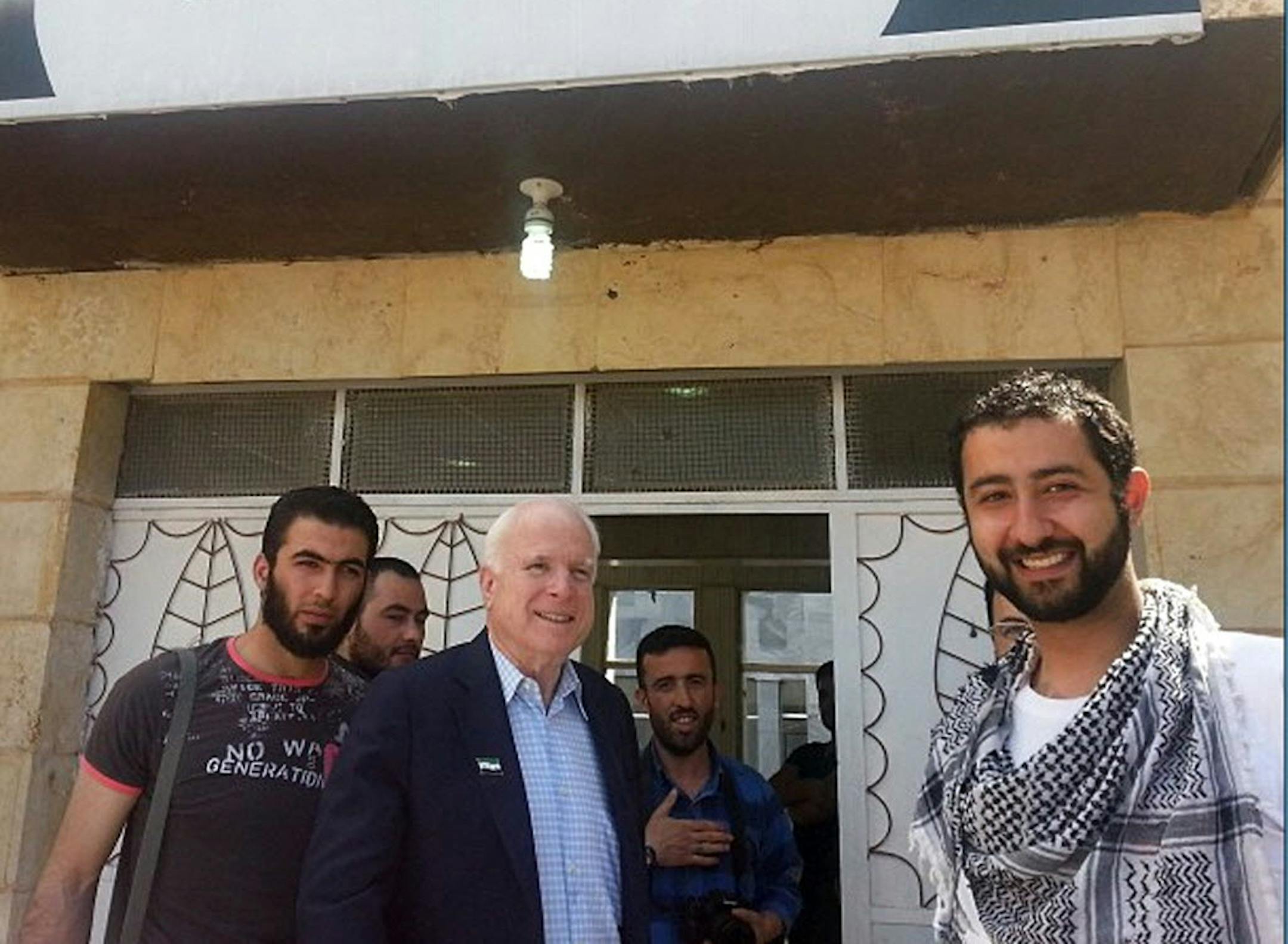 In this Monday, May 27, 2013 photo provided by Mouaz Moustafa and the Syrian Emergency Task Force, Sen. John McCain, center, accompanied by Moustafa, right, visits rebels in Syria.