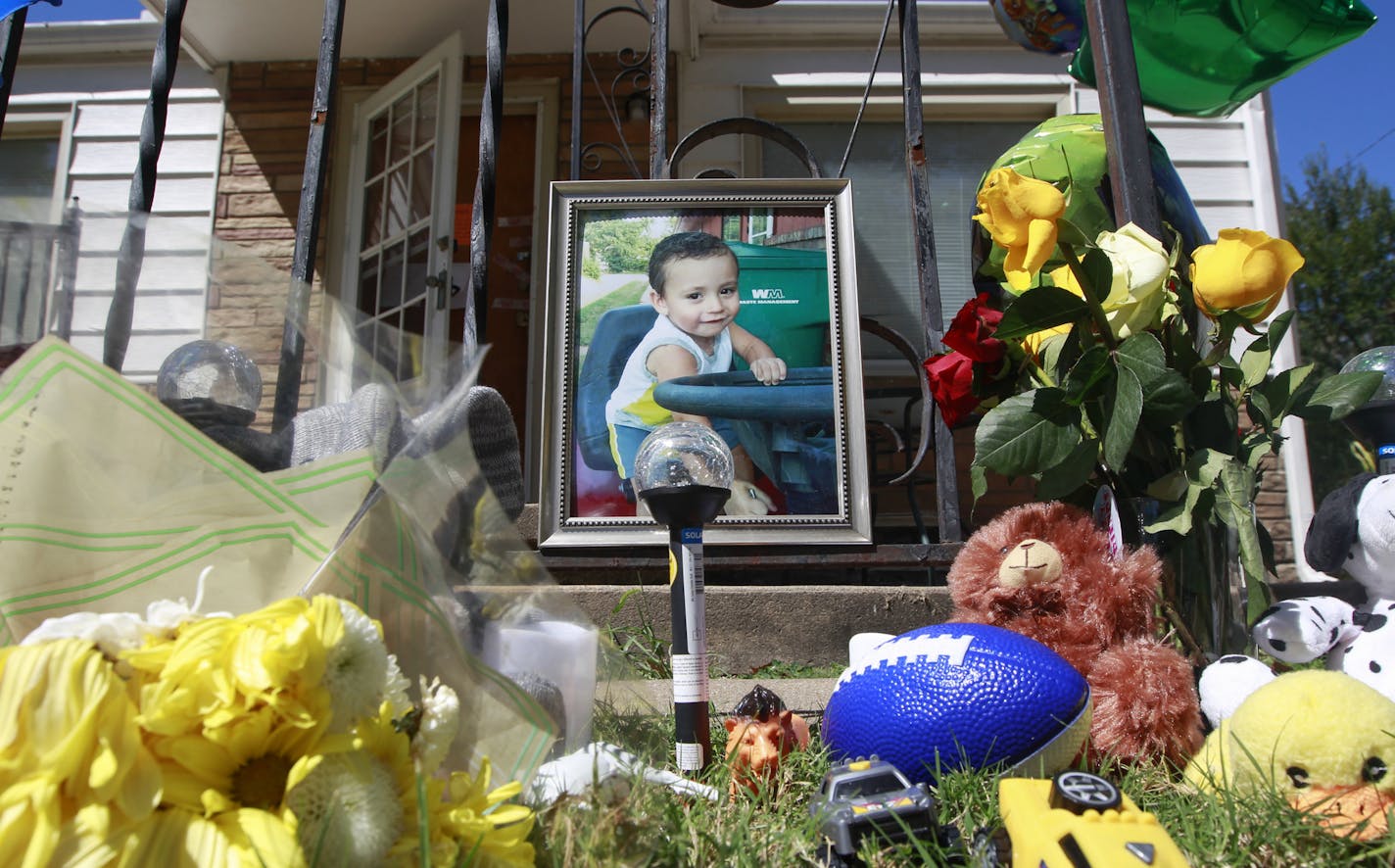 A memorial to three-year-old Evan Brewer sits in front of a home in Wichita, Kan., Wednesday, Sept. 6, 2017. A boy, whose body was found encased in concrete in a Wichita rental home, is believed to be the son of a woman named in an order seeking to protect him from abuse, police said Tuesday. Wichita police Lt. Jeff Gilmore told reporters that the body found Saturday in the rental home is likely that of Brewer, though authorities are awaiting DNA results for final confirmation. (Fernando Salazar