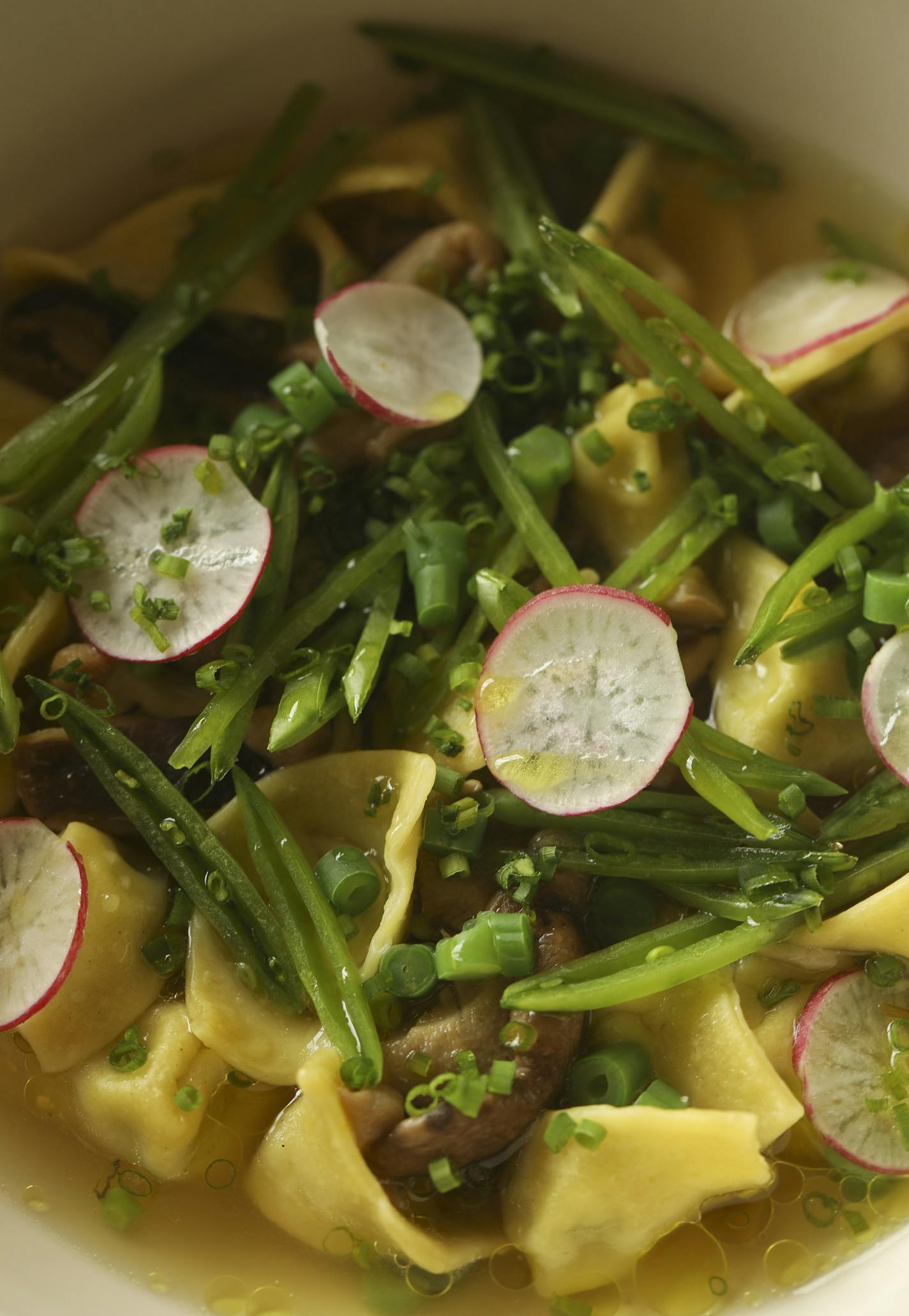 The Tortelli, with peas, ricotta, conserved mushrooms, brodo, and spring vegetables at the Bungalow Club.