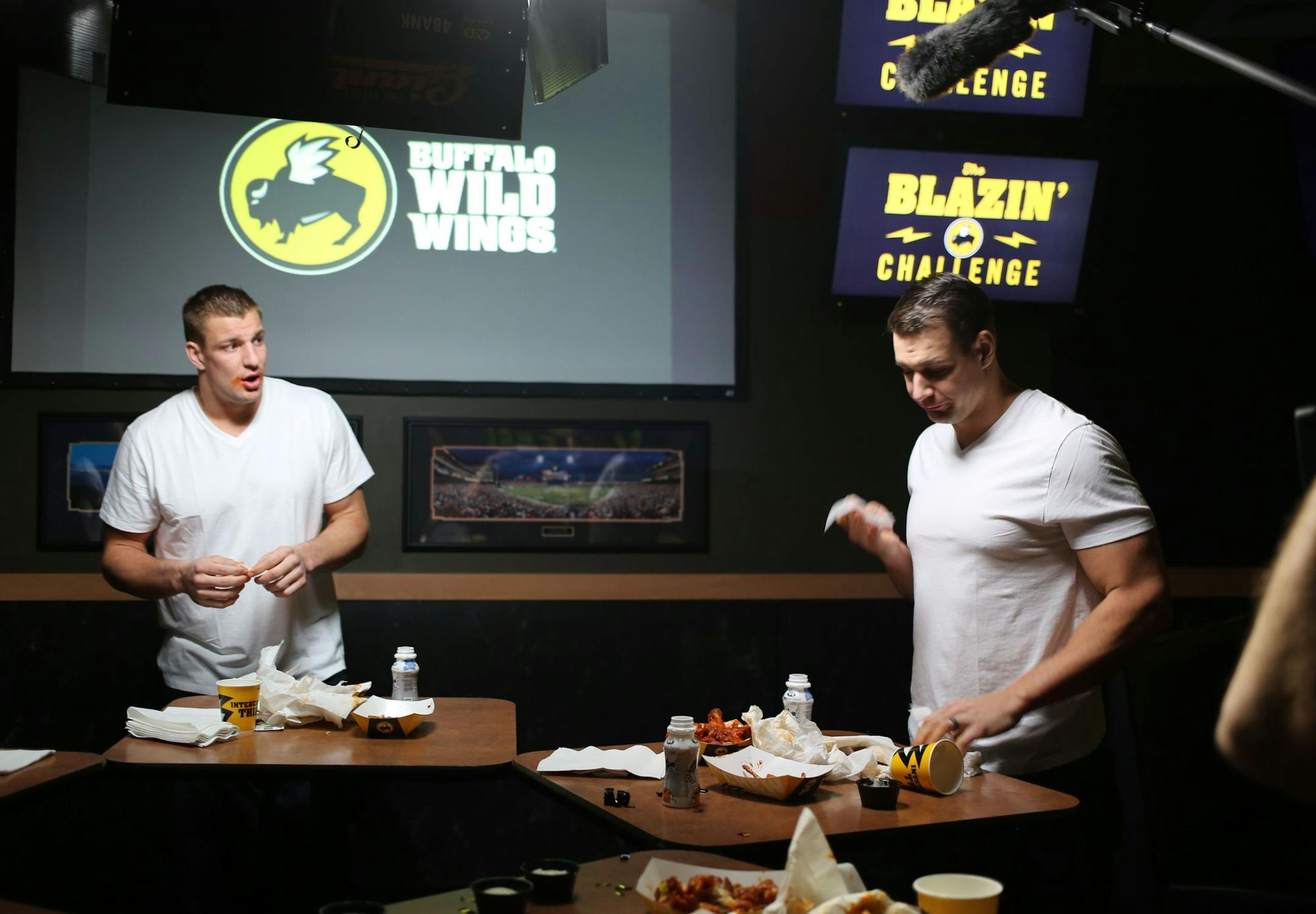 New England Patriots tight end Rob Gronkowski (left) takes Buffalo Wild Wings' Blazin Challenge with his brother Dan (right).