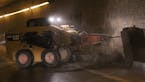 Workers use a large jackhammer to destroy the curbs on either side of the Lowry Hill Tunnel to make enough room for another lane. It's powerful enough