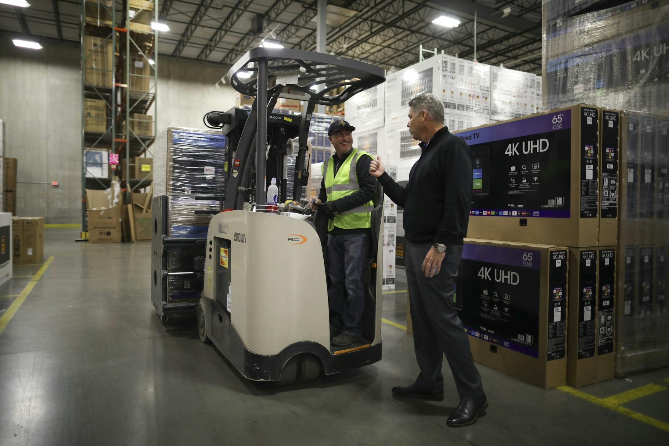 Rob Bass, Best Buy's Chief Supply Chain Officer, visited with Todd Lothert while leading a tour of the company's Bloomington distribution center Monday afternoon. He stood in a section of the warehouse dominated by large televisions and appliances.