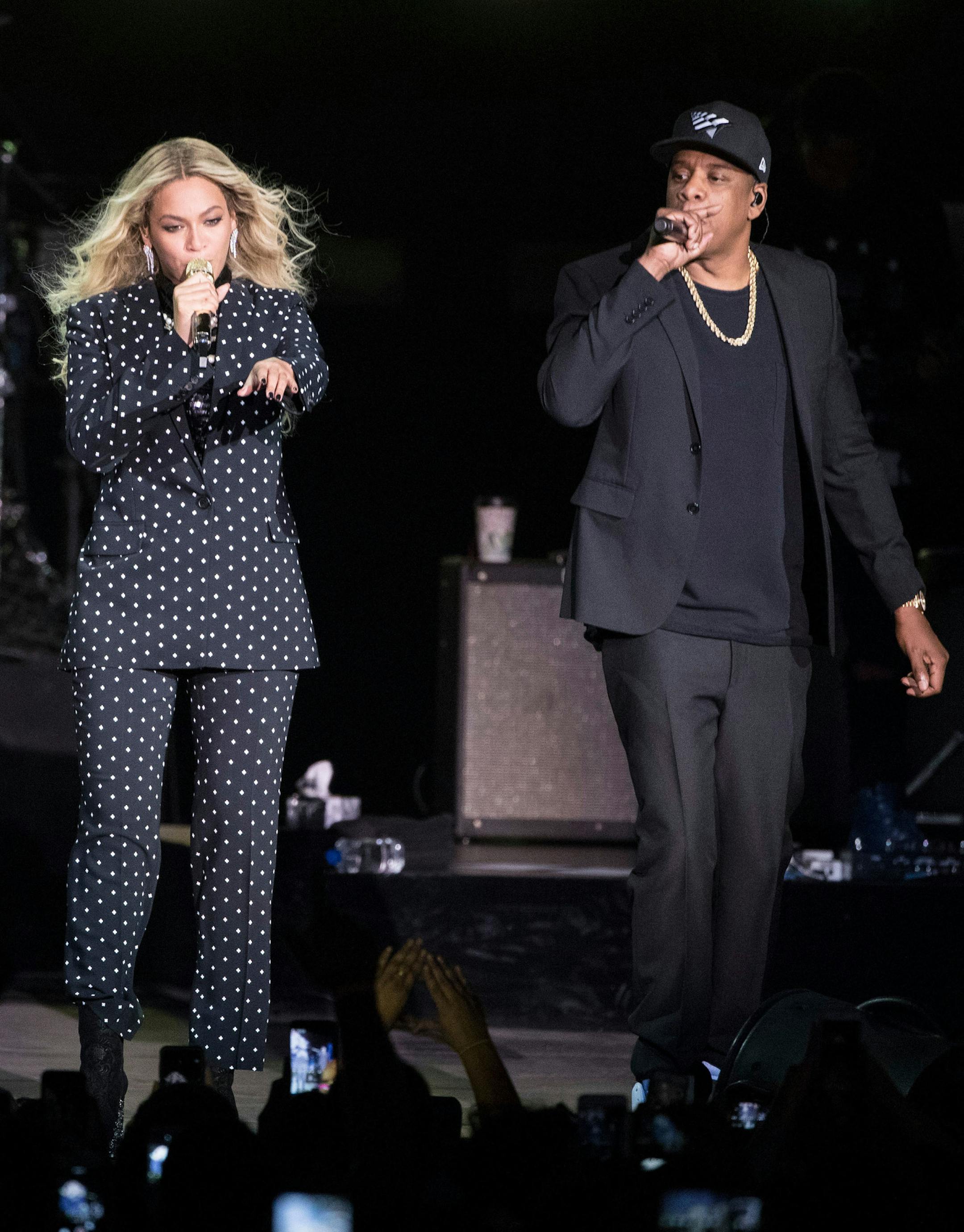 FILE - In this Nov. 4, 2016 file photo, Beyonce, center, and Jay-Z perform during a Democratic presidential candidate Hillary Clinton campaign rally in Cleveland. Beyonce performed a 2-hour set at Coachella, Saturday, April 14, 2018, paying tribute to the marching bands, the dance troupes and step teams at historically black colleges and universities. Jay-Z also came out for a collaboration.( AP Photo/Matt Rourke, File)