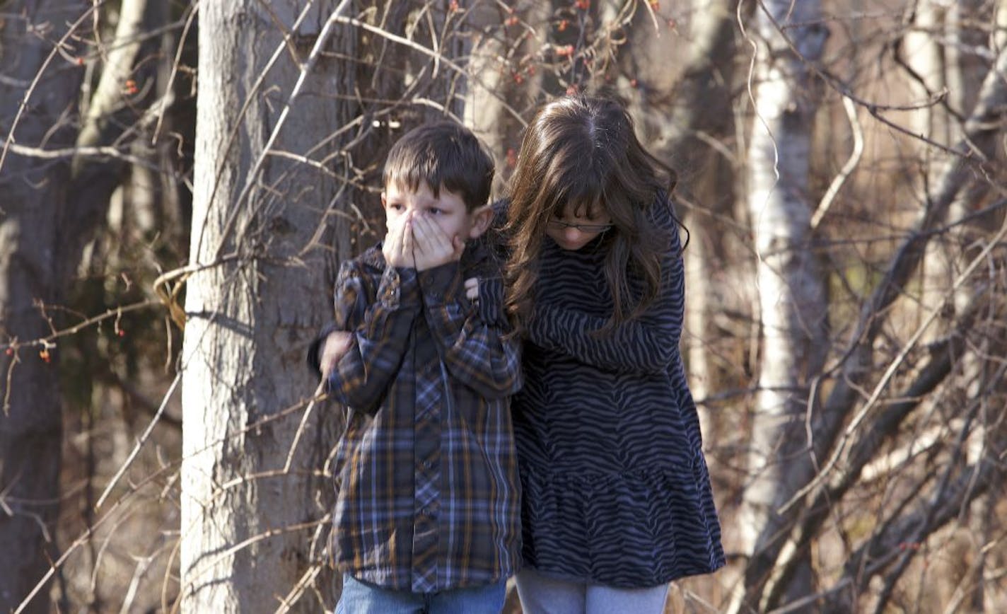 Young children wait outside Sandy Hook Elementary School after a shooting in Newtown, Connecticut, December 14, 2012. A shooter opened fire at the elementary school in Newtown, Connecticut, on Friday, killing multiple people including children.