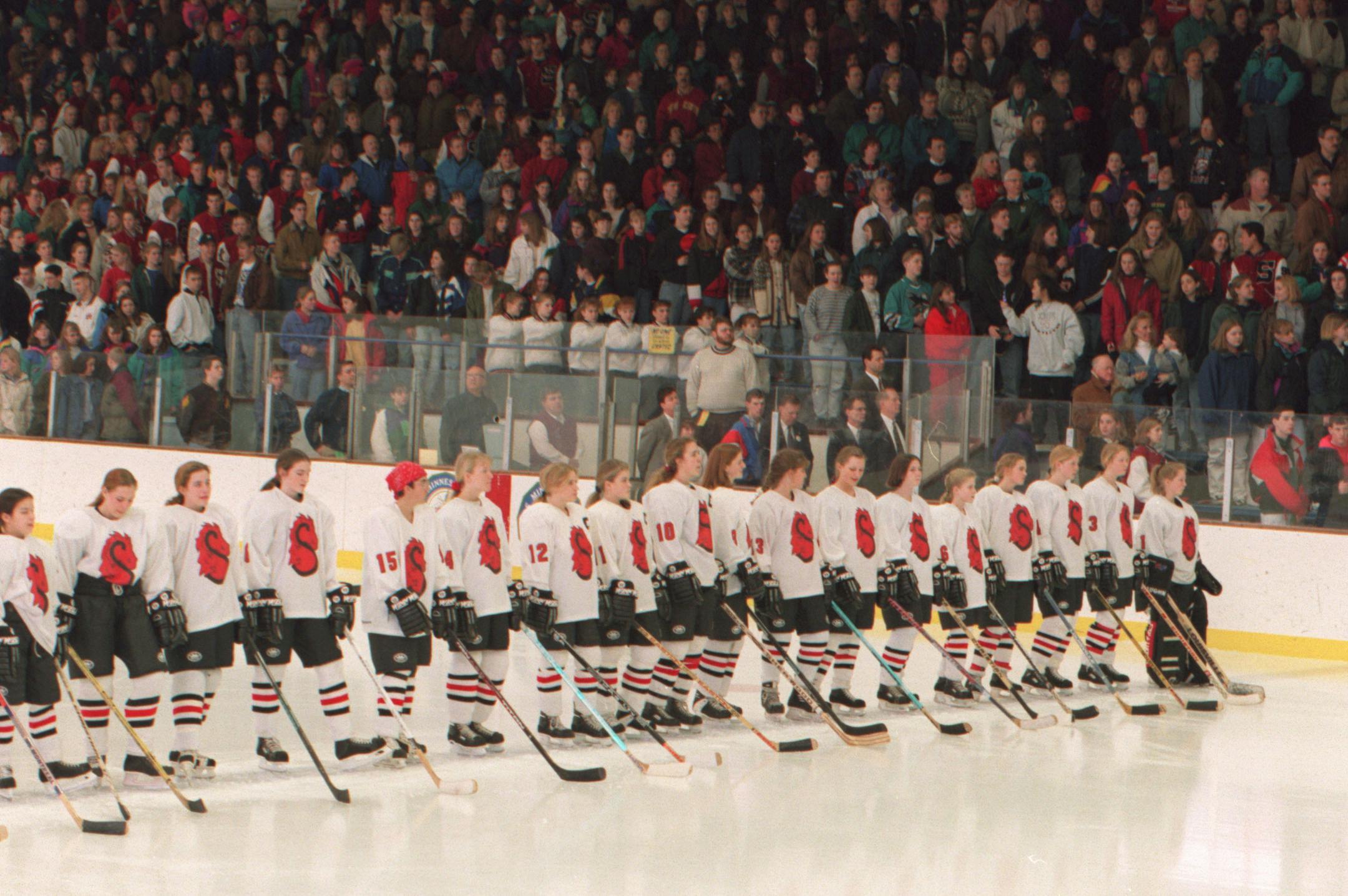 Members of the Stillwater girls hockey team line up for the playing of the national athem, before the start of the 1st girls sanctioned hockey tournment ever held in the United States. Stillwater played Apple Valley in the game. staff photo by Jerry Holt. ORG XMIT: MIN2014021818322313
