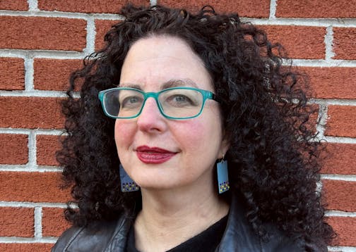 photo of author Emily Nussbaum in front of a brick wall