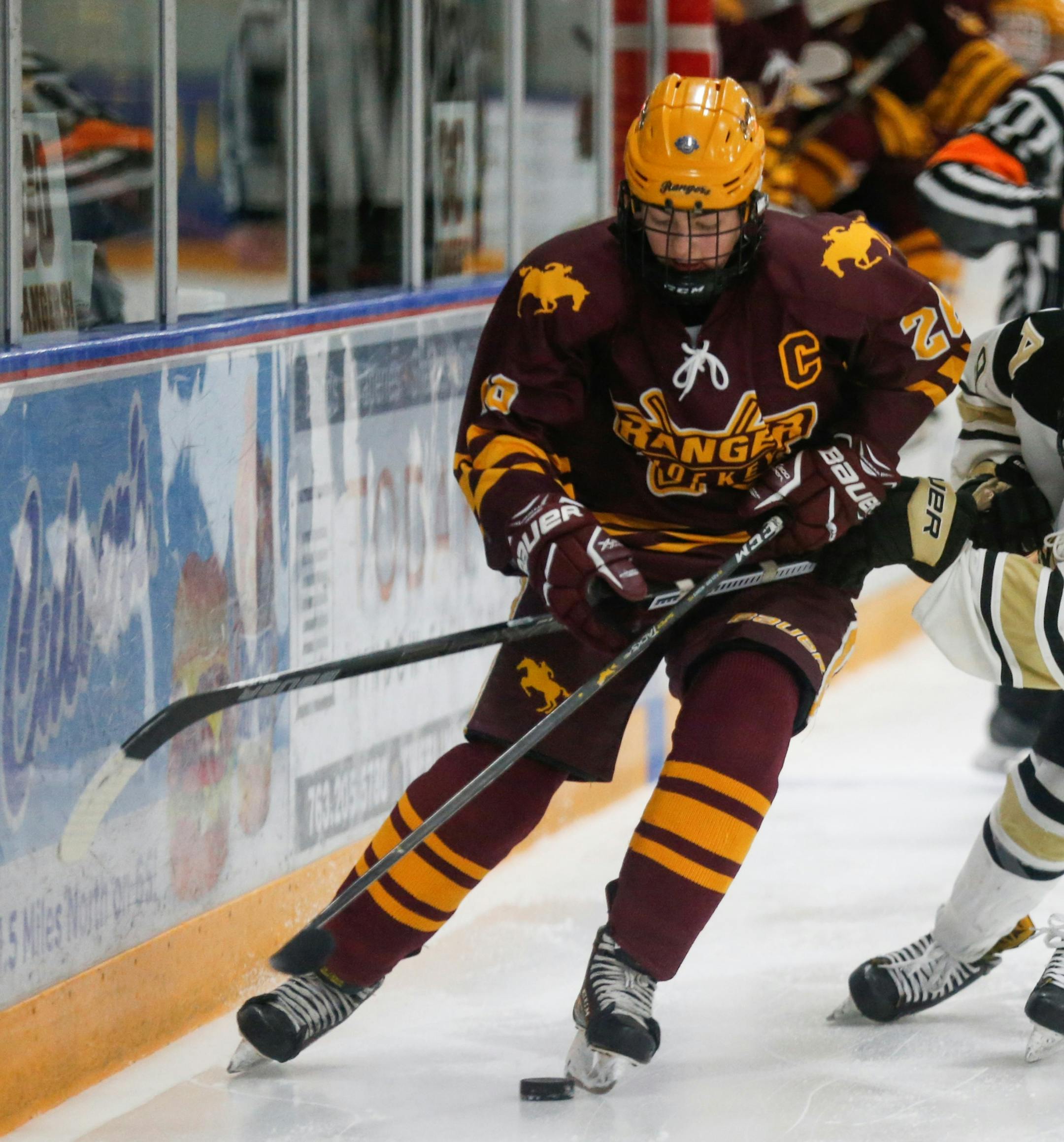 Forest Lake's Rachel Golnitz (26) battles for control of the puck along the boards with Andover's Elisebeth Tammi (9) during the Class 2A, Section 7 Championship on Thursday, Feb. 13, 2020. The Rangers trailed the Huskies 6-0 after two periods. Photo by Jeff Lawler, SportsEngine