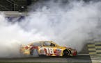 Kyle Busch (18) celebrates after winning a NASCAR Sprint Cup Series auto race at Kansas Speedway in Kansas City, Kan., Saturday, May 7, 2016. (AP Phot