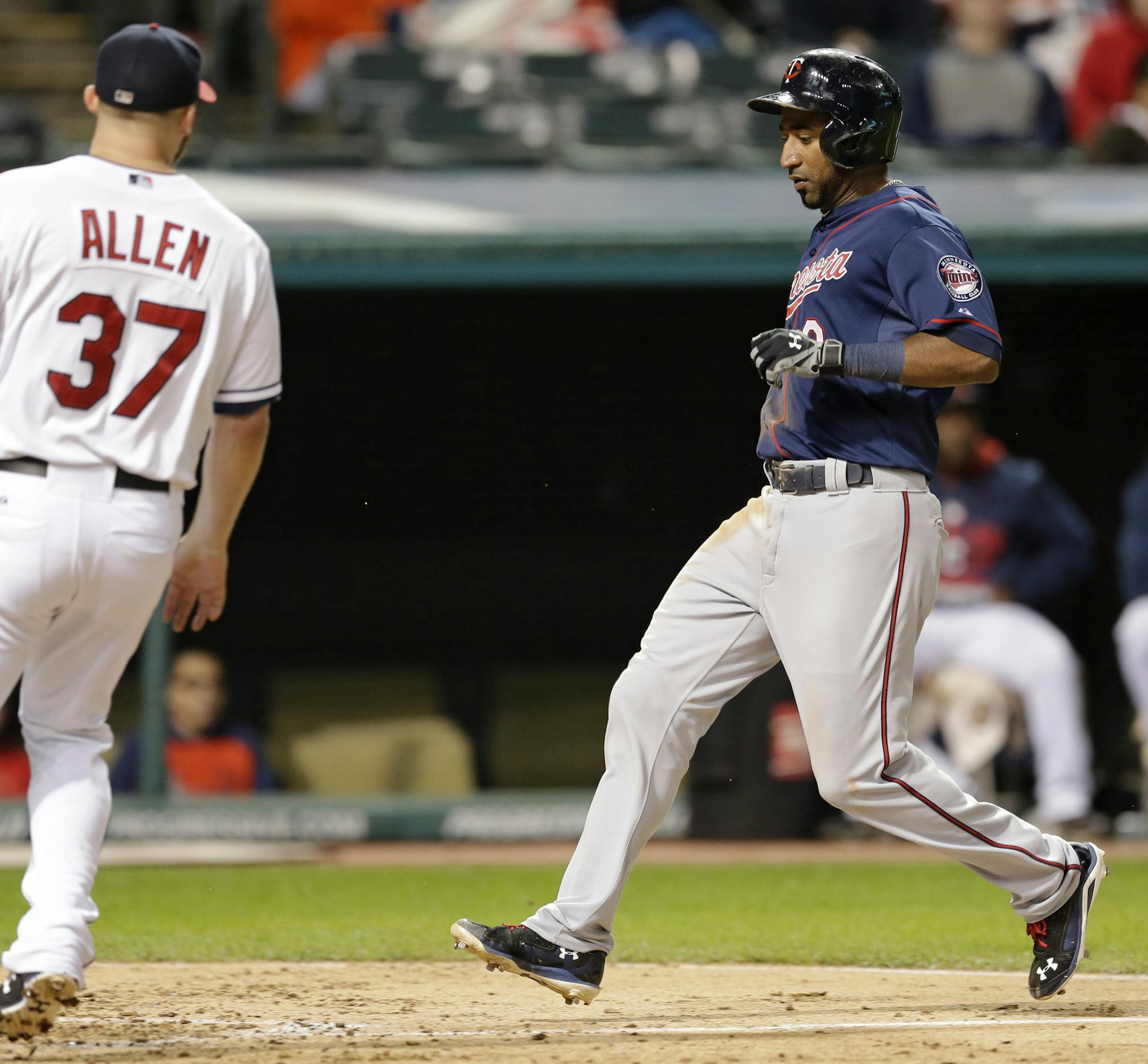 Minnesota Twins' Eduardo Nunez scores on a wild pitch by Cleveland Indians relief pitcher Cody Allen in the ninth inning of a baseball game, Thursday, Oct. 1, 2015, in Cleveland. The Twins won 4-2. (AP Photo/Tony Dejak)