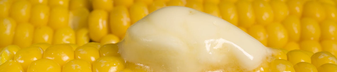 Close up of corn on the cob with melted margarine. iStock