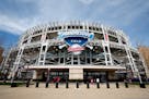 Fans walk in front of Progressive Field before the Cleveland Guardians play the Seattle Mariners in a baseball game, Friday, April 7, 2023, in Clevela