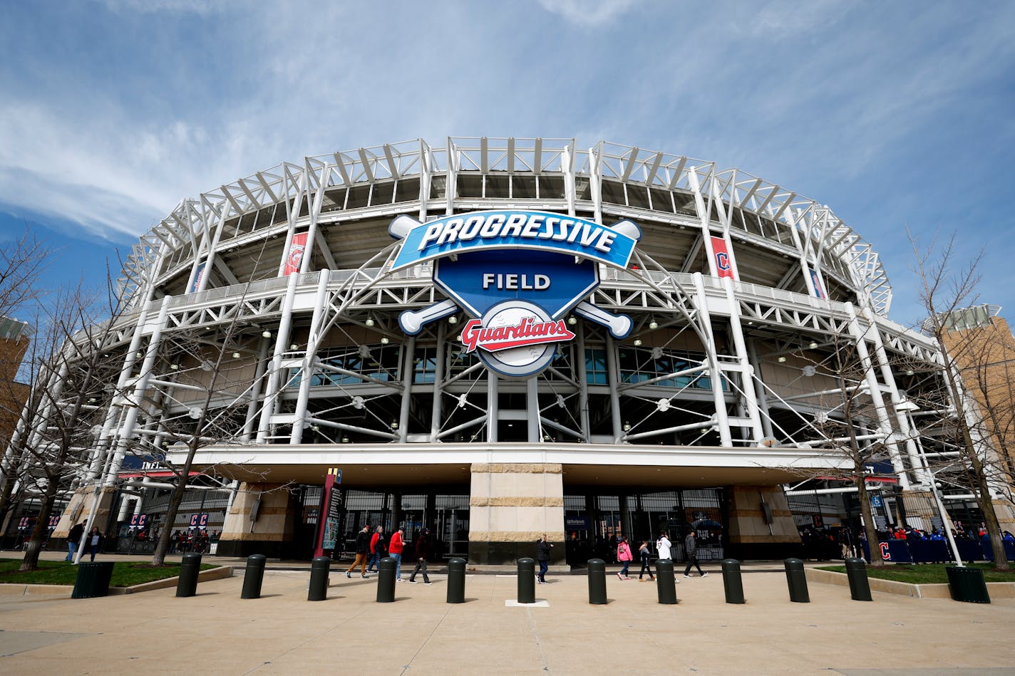 Fans walk in front of Progressive Field before the Cleveland Guardians play the Seattle Mariners in a baseball game, Friday, April 7, 2023, in Cleveland. (AP Photo/Ron Schwane)