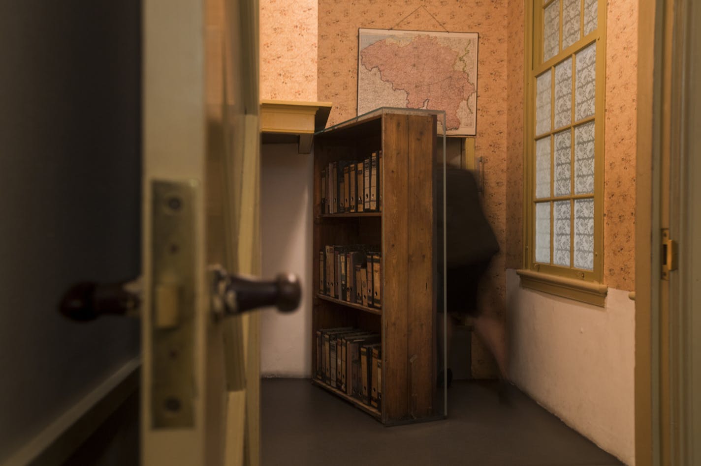 A woman enters the secret annex at the renovated Anne Frank House Museum in Amsterdam, Netherlands, Wednesday, Nov. 21, 2018. The museum is built around the secret annex hidden in an Amsterdam canal-side house where teenage Jewish diarist Anne Frank hid from Nazi occupiers during World War II is expanding to better tell Anne's tragic story to the growing number of visitors.